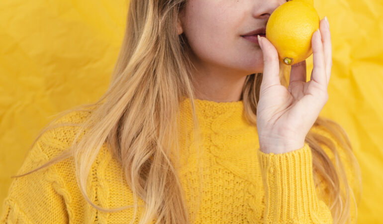 medium shot woman smelling lemon medium shot woman smelling lemon