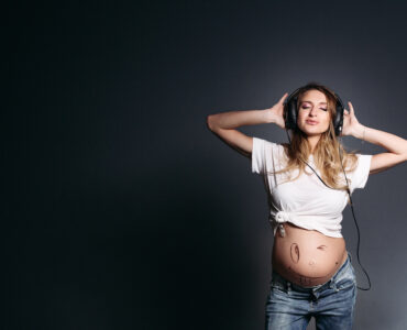 pregnant woman dancing smiling with closed eyes pregnant woman dancing smiling with closed eyes