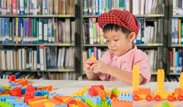 boy playing with plastic blocks library room school boy playing with plastic blocks library room school