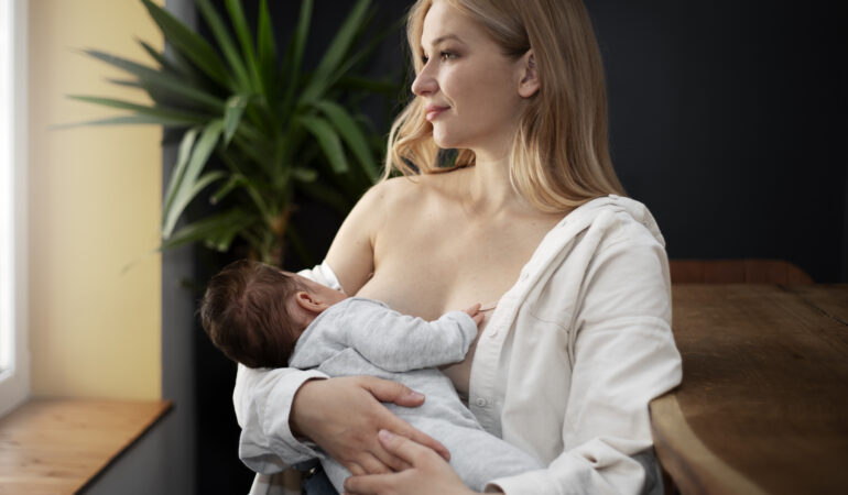 mom gently breast feeding her child mom gently breast feeding her child